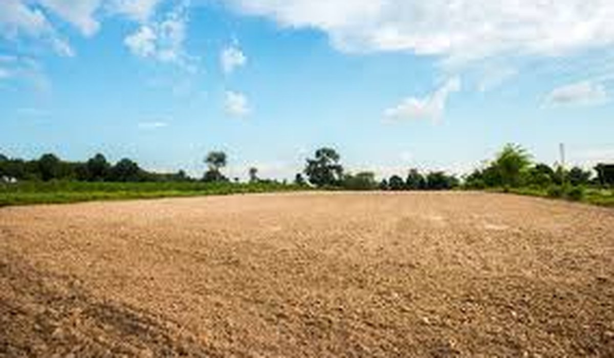 Cleared dirt lot under blue sky (sample deal)